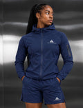 Female model wearing a GE navy blue hooded zip jacket and matching shorts with white GE Peak Performance logos.