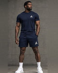 Male model wearing a navy blue GE crew-neck T-shirt and matching above-the-knee shorts with contrasting white GE logos.