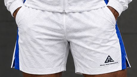 GE white above-the-knee shorts with blue side panels, side pockets and GE Peak Performance logo.